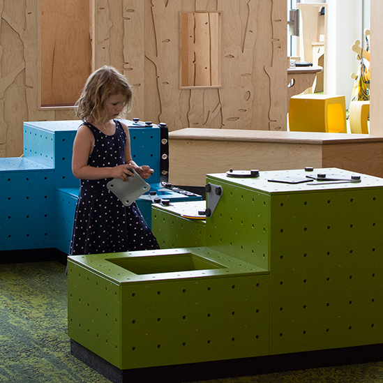 girl playing with engineering blocks